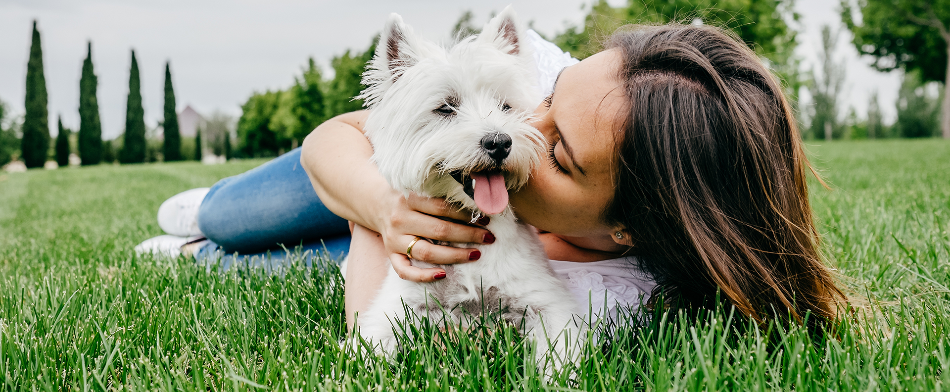 Woman kissing Westie